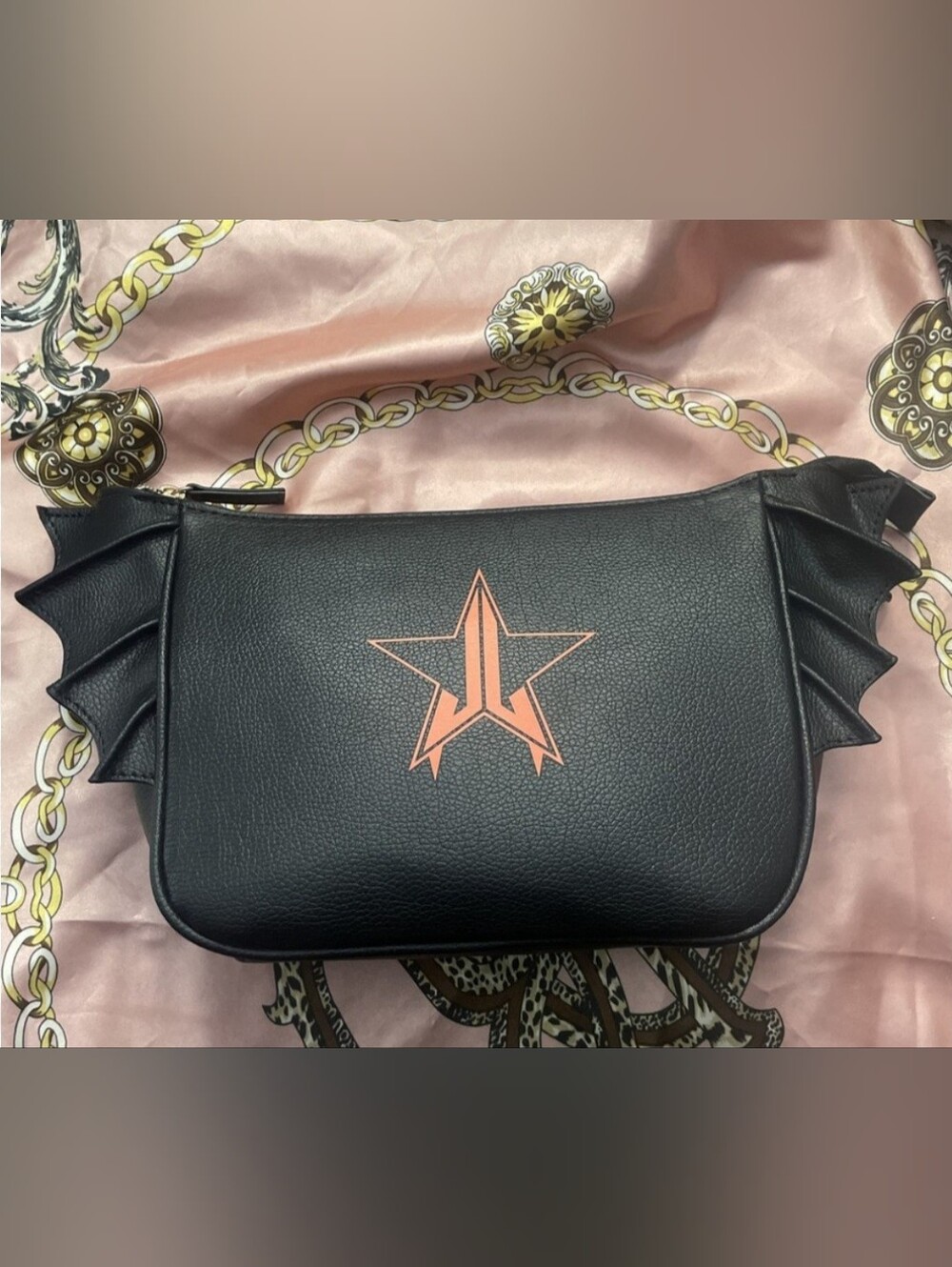 This is a black Jeffree Star Cosmetics bat-shaped makeup bag